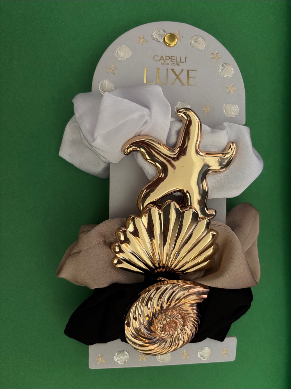 Capelli of New York set a three gold seashell inspired hair twist